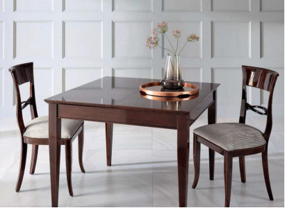 Elegant dining table with chairs in dark brown color with shiny surface