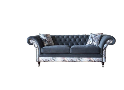 A striking three-seater sofa in a Chesterfield design with delicate gray floral decoration