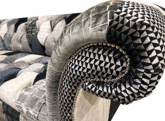 Luxurious velvet sofa in Chesterfield design with colorful checks
