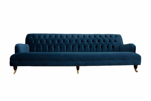 Luxurious designer sofa in Chesterfield style with four seats in the color blue