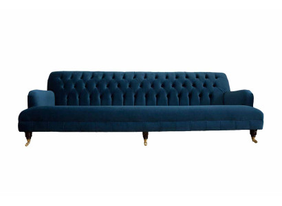 Luxurious designer sofa in Chesterfield style with four seats in the color blue