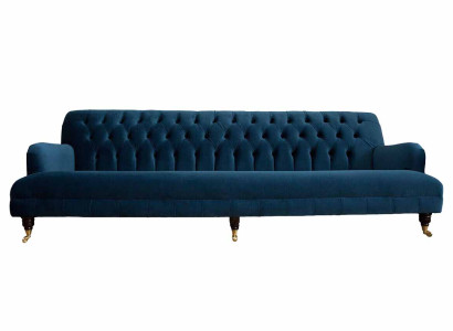 Luxurious designer sofa in Chesterfield style with four seats in the color blue