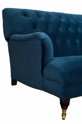 Luxurious designer sofa in Chesterfield style with four seats in the color blue