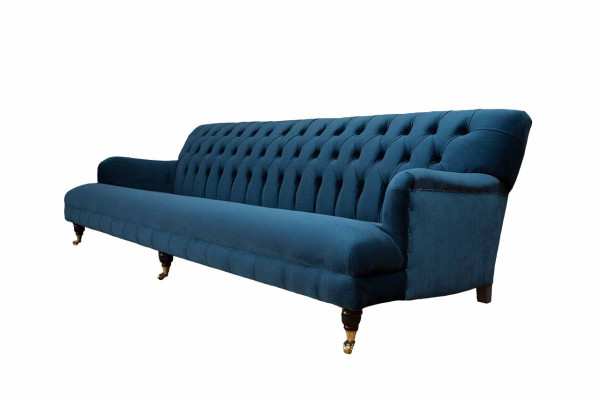 Luxurious designer sofa in Chesterfield style with four seats in the color blue