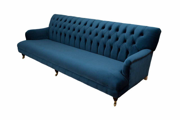Luxurious designer sofa in Chesterfield style with four seats in the color blue