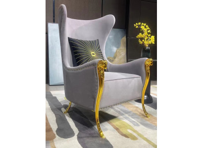Luxurious armchair with decorative elements and gold-plated legs