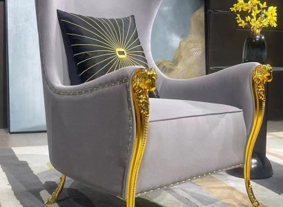 Luxurious armchair with decorative elements and gold-plated legs
