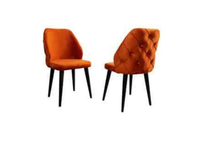 Upholstered wooden chair orange Chesterfield on black legs in the dining room