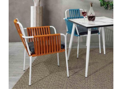 Original chairs light orange color on white stainless steel legs with soft cushions