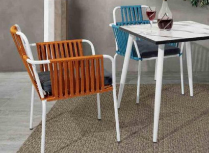 Original chairs light orange color on white stainless steel legs with soft cushions