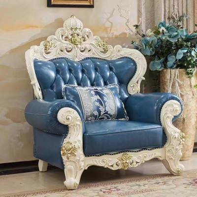 Luxurious Chesterfield style leather armchair in stylish blue with decorative carvings