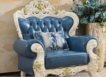 Luxurious Chesterfield style leather armchair in stylish blue with decorative carvings